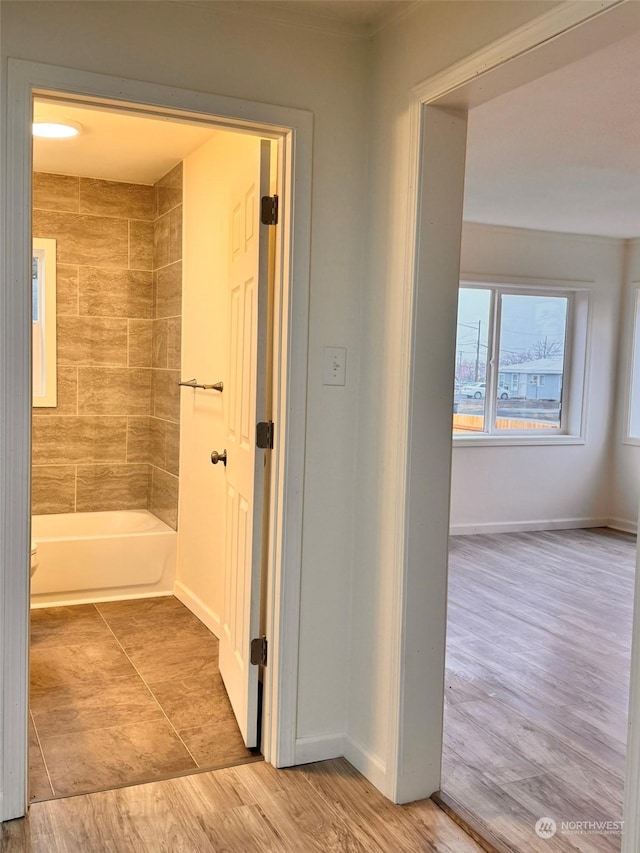 bathroom featuring hardwood / wood-style floors and a washtub