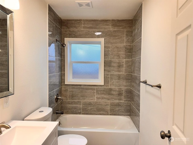 full bathroom featuring vanity, toilet, and tiled shower / bath