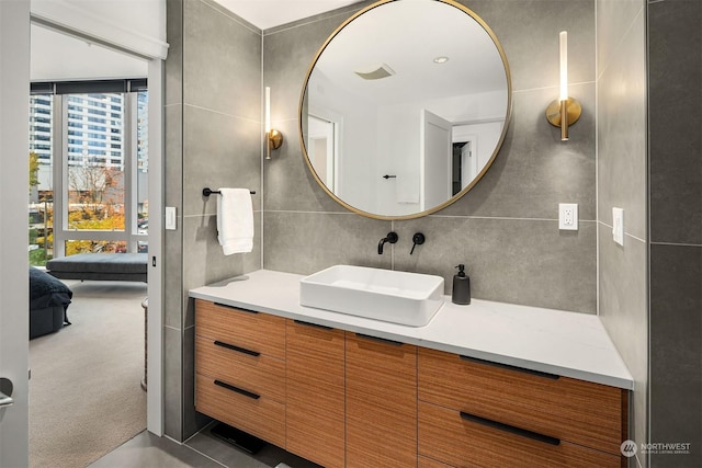 bathroom with vanity and tile walls