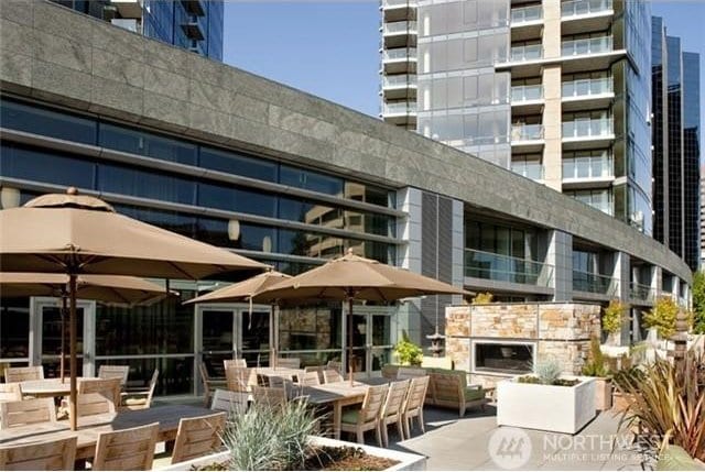 view of patio with exterior fireplace