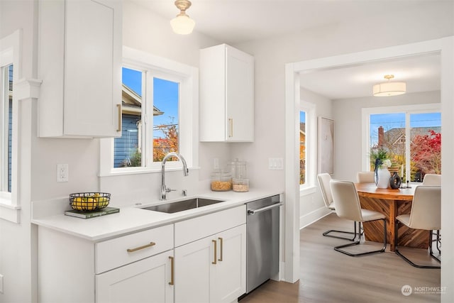 kitchen featuring white cabinetry, sink, and a healthy amount of sunlight