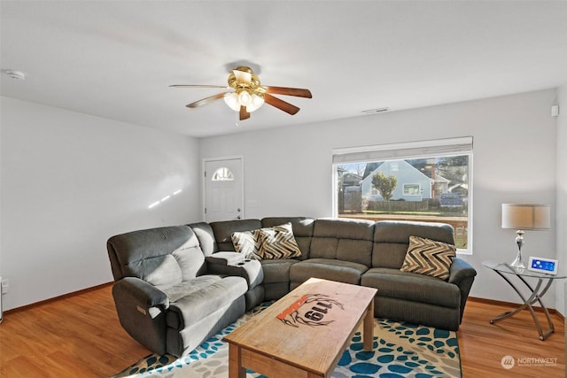 living room featuring ceiling fan and wood-type flooring