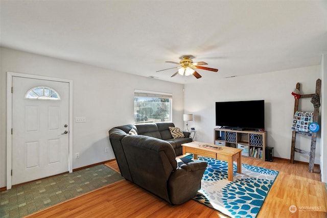 living room featuring ceiling fan and hardwood / wood-style floors