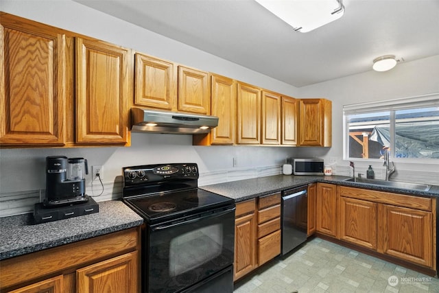 kitchen featuring dark stone countertops, sink, and appliances with stainless steel finishes