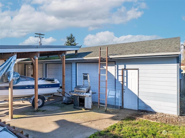 back of property with a garage