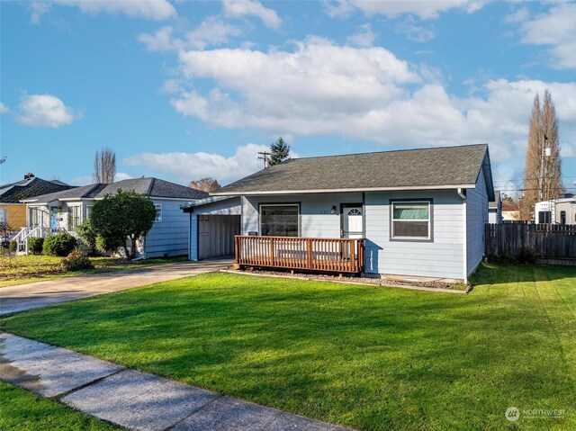 ranch-style home with a wooden deck and a front yard