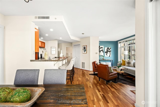 dining space featuring wood-type flooring