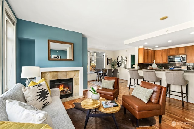 living room with light wood-type flooring and a fireplace