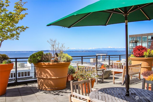 balcony featuring a water and mountain view