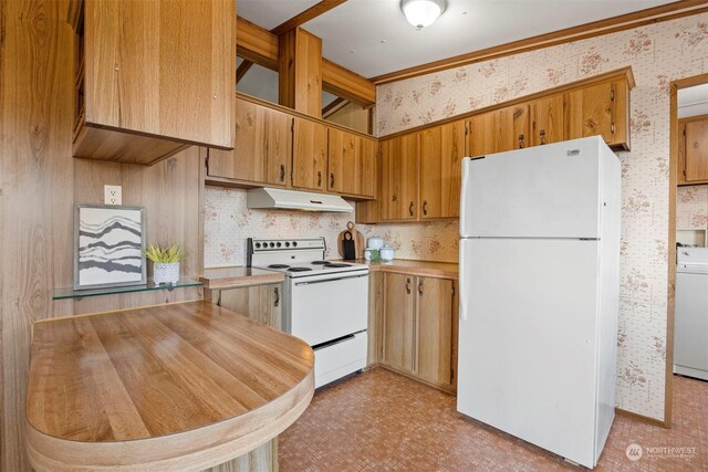 kitchen with washer / dryer and white appliances