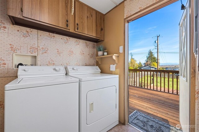 washroom featuring light hardwood / wood-style floors, cabinets, separate washer and dryer, and a wealth of natural light