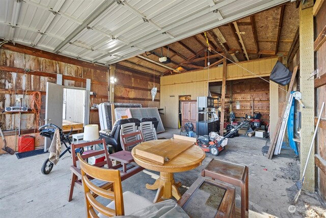 garage with a garage door opener and wood walls