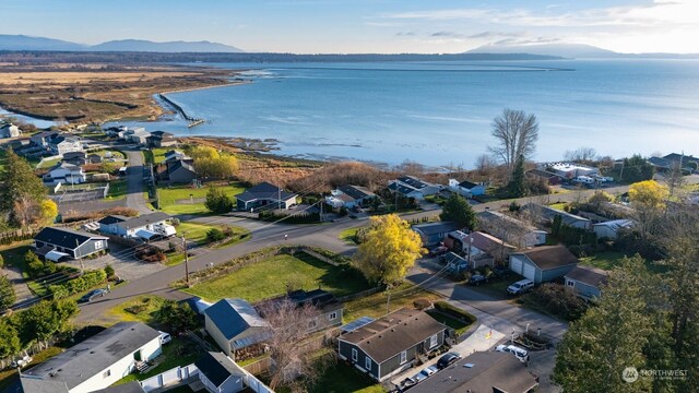 drone / aerial view with a water and mountain view