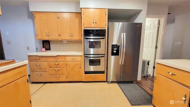 kitchen with tasteful backsplash, stainless steel appliances, and light countertops