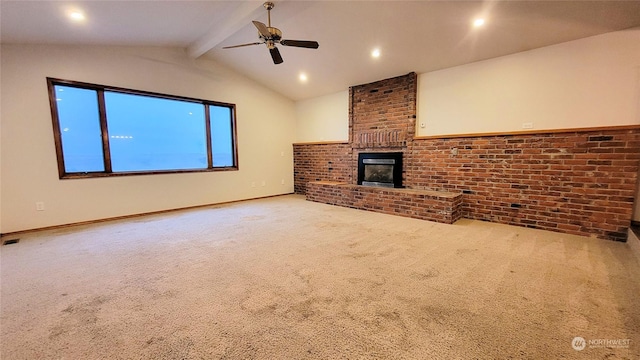 unfurnished living room with a brick fireplace, brick wall, ceiling fan, carpet, and lofted ceiling with beams