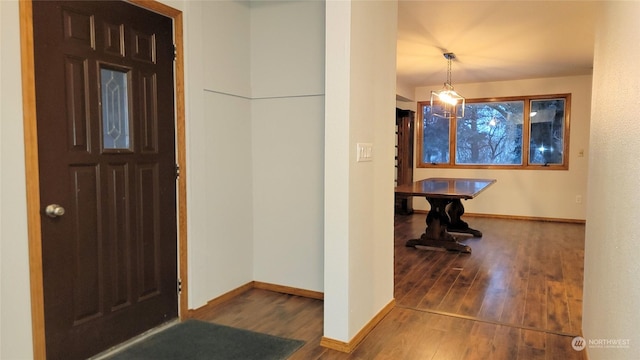 entryway with baseboards and wood finished floors