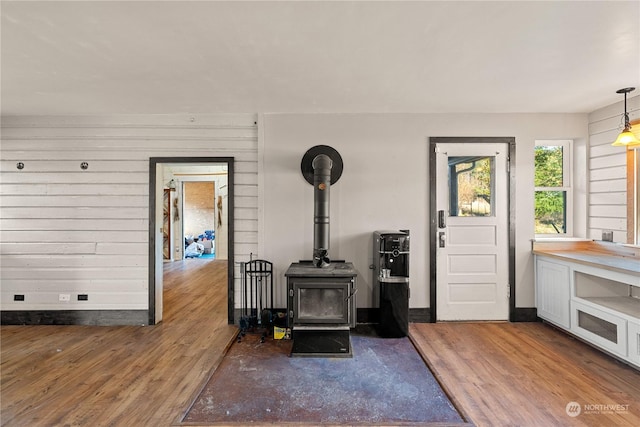 living room featuring a wood stove and dark hardwood / wood-style floors