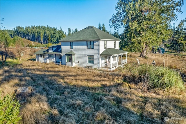 rear view of house with a porch