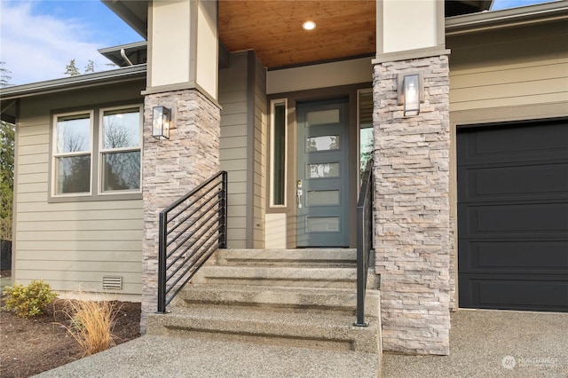 doorway to property with a garage