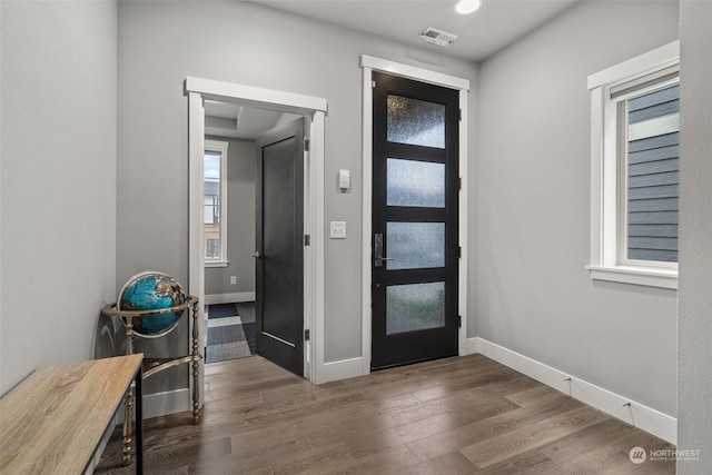 entryway with dark hardwood / wood-style flooring