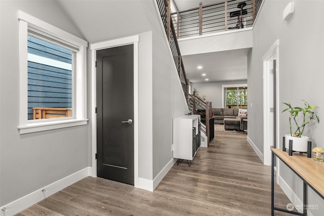 entrance foyer featuring hardwood / wood-style floors and lofted ceiling