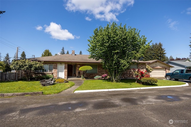 ranch-style home with a front yard and a garage