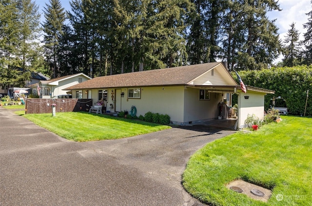 ranch-style home with a front yard and a carport