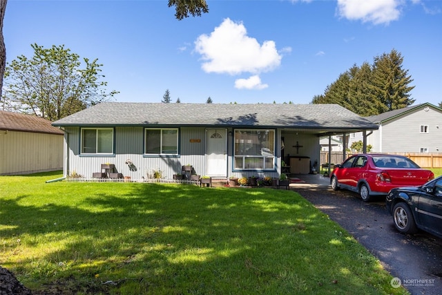 ranch-style home featuring a front yard and a carport