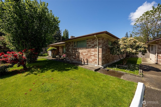 view of home's exterior with a lawn