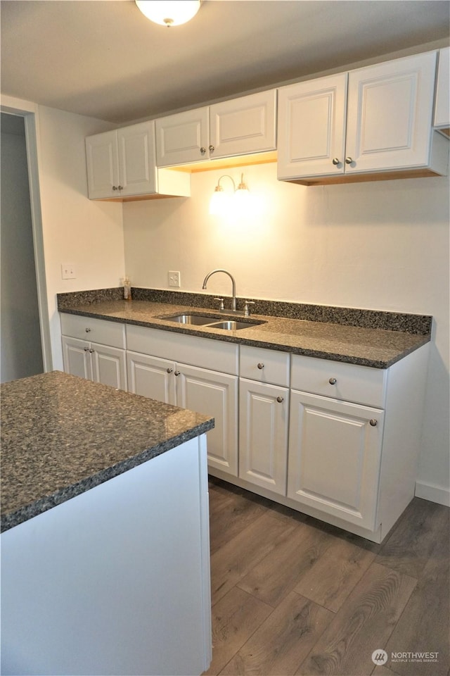 kitchen featuring sink, white cabinets, and dark wood-type flooring