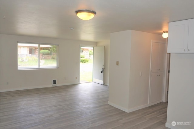 empty room with light hardwood / wood-style flooring