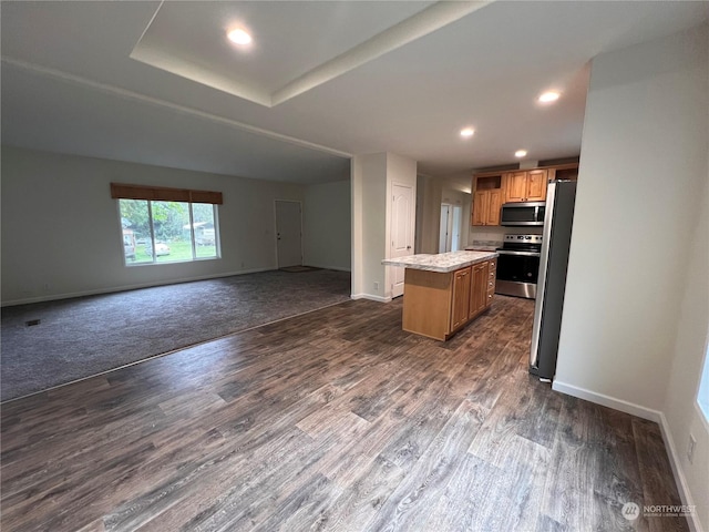 16818 57th St NW, Vaughn, WA 98394 - kitchen featuring appliances with stainless steel finishes, open floor plan, a center island, dark wood finished floors, and recessed lighting
