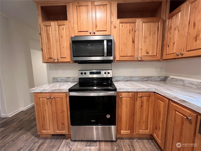 16818 57th St NW, Vaughn, WA 98394 - kitchen with appliances with stainless steel finishes, dark wood-style floors, and light countertops