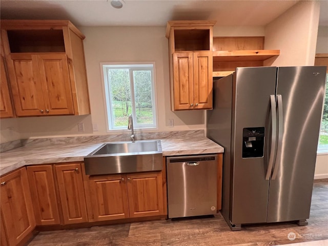 16818 57th St NW, Vaughn, WA 98394 - kitchen featuring appliances with stainless steel finishes, open shelves, healthy amount of natural light, and wood finished floors