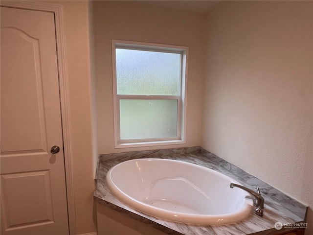 bathroom featuring a tub to relax in