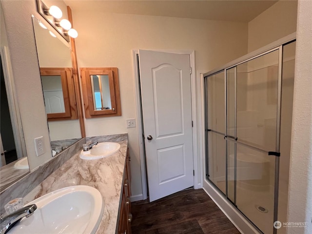 16818 57th St NW, Vaughn, WA 98394 - bathroom with wood finished floors, a stall shower, and double vanity
