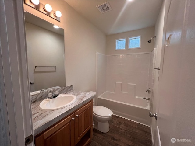 full bathroom with shower / tub combination, vanity, wood-type flooring, and toilet