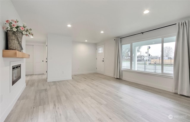 unfurnished living room with light hardwood / wood-style flooring