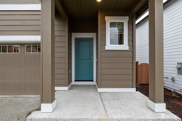 doorway to property with a garage