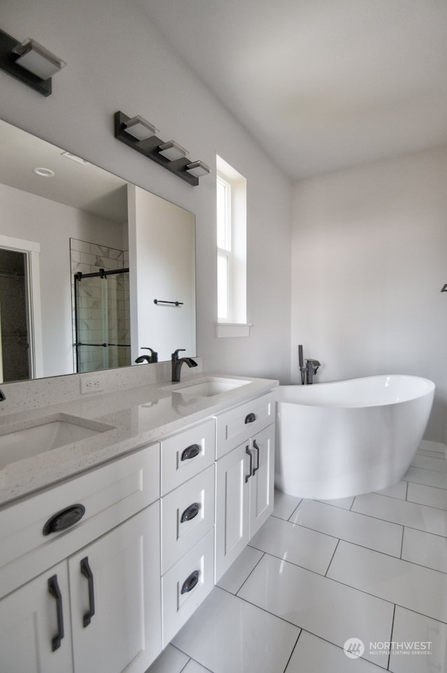 bathroom featuring vanity and independent shower and bath