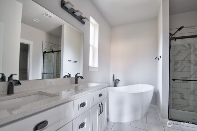 bathroom featuring independent shower and bath, vanity, and tile patterned flooring