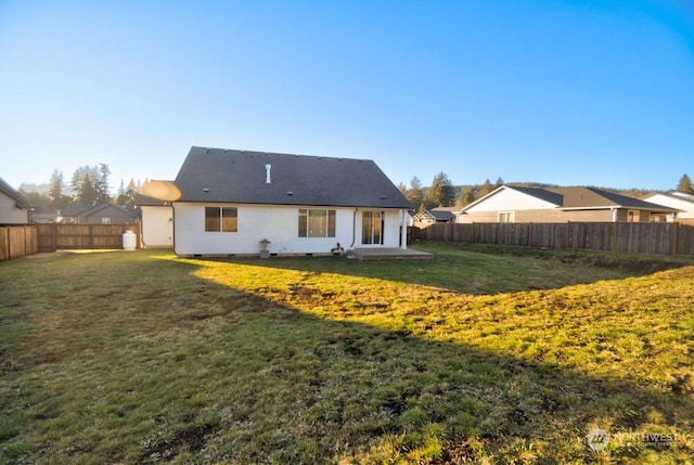 back of house with a lawn