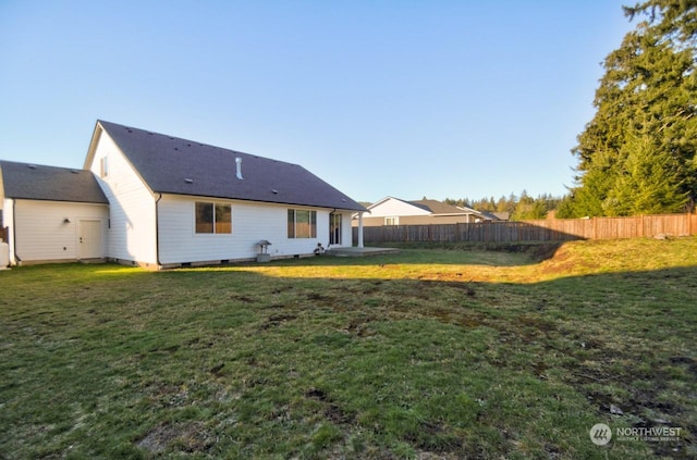 back of house featuring a lawn