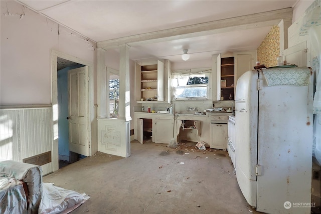 kitchen featuring white cabinets, open shelves, and freestanding refrigerator