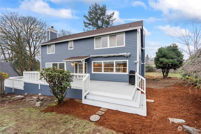 rear view of property featuring a deck