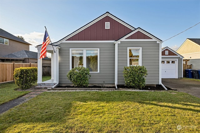 view of front of property with a garage and a front lawn