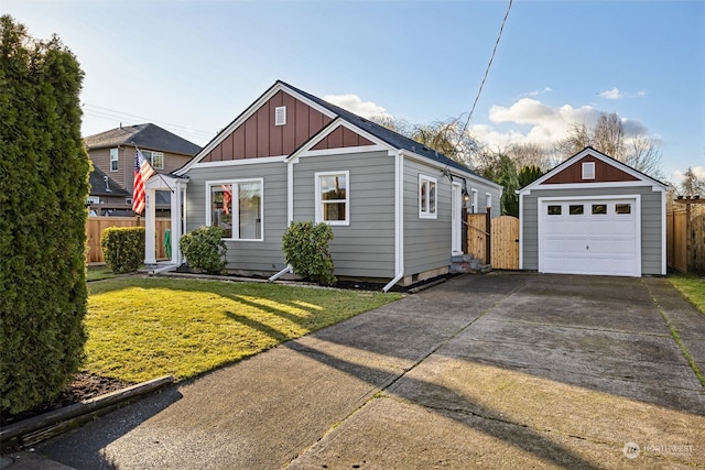 view of front facade featuring a front yard, an outdoor structure, and a garage