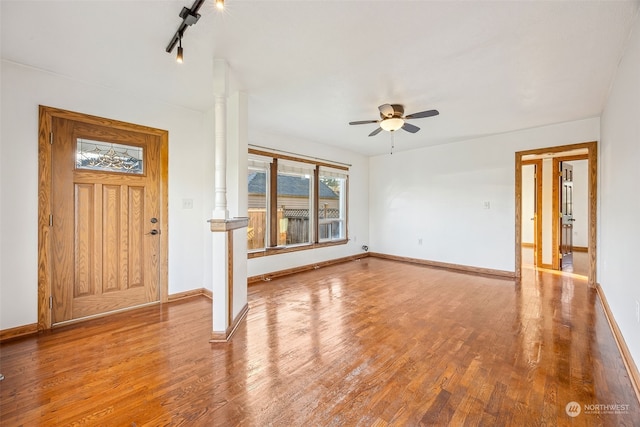 entryway featuring wood-type flooring, track lighting, ornate columns, and ceiling fan