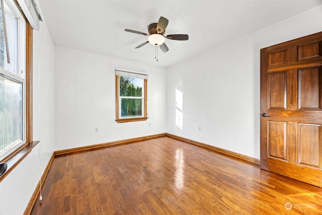 spare room with ceiling fan and wood-type flooring