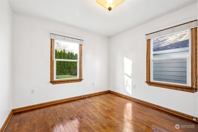 spare room featuring hardwood / wood-style flooring